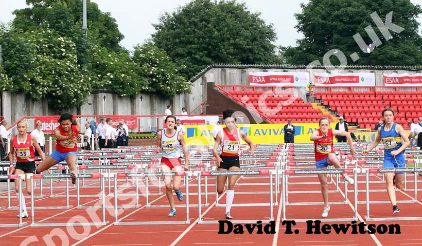 Far left No 19 Alicia Barrett (Derby) wins from No 20 Emma Schaanning (Derby) and No 67 Hollie Williamson (Shrop) in the Junior Girls 75 metres Hurdles.